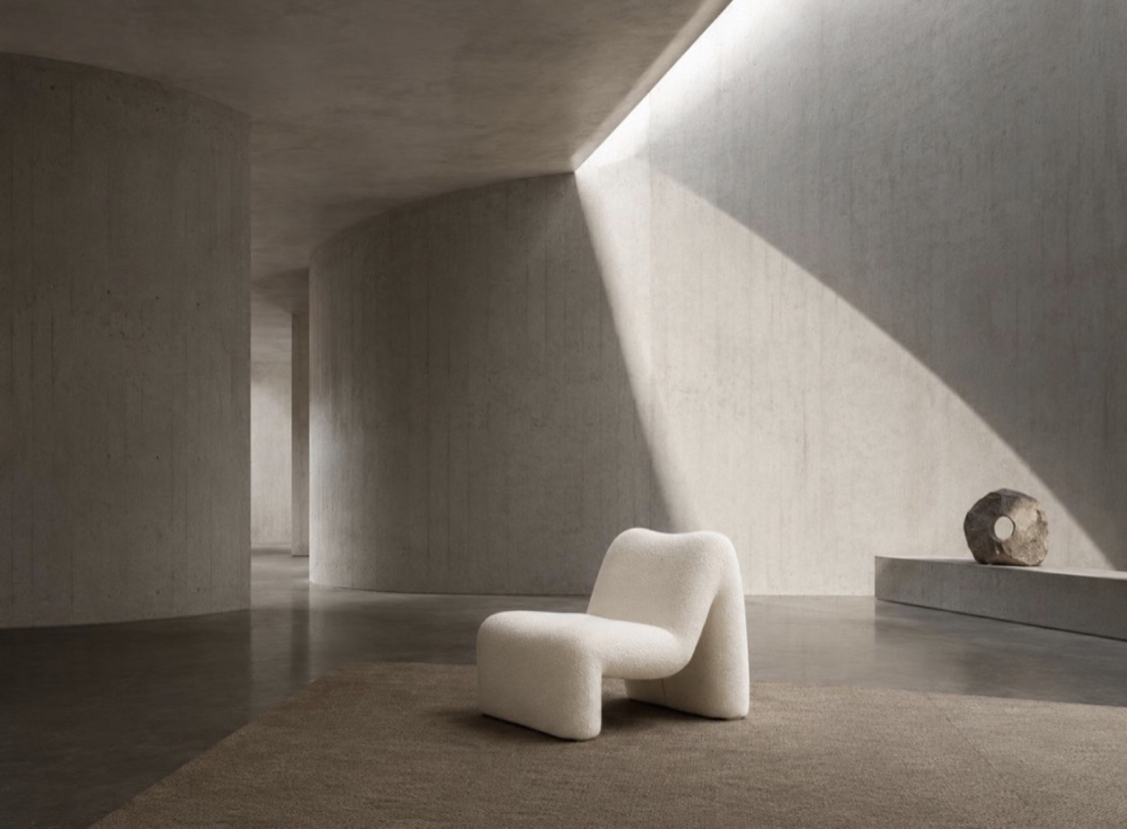fauteuil sculptural blanc bouclé dans un espace en béton minimaliste — ayyur interiors.