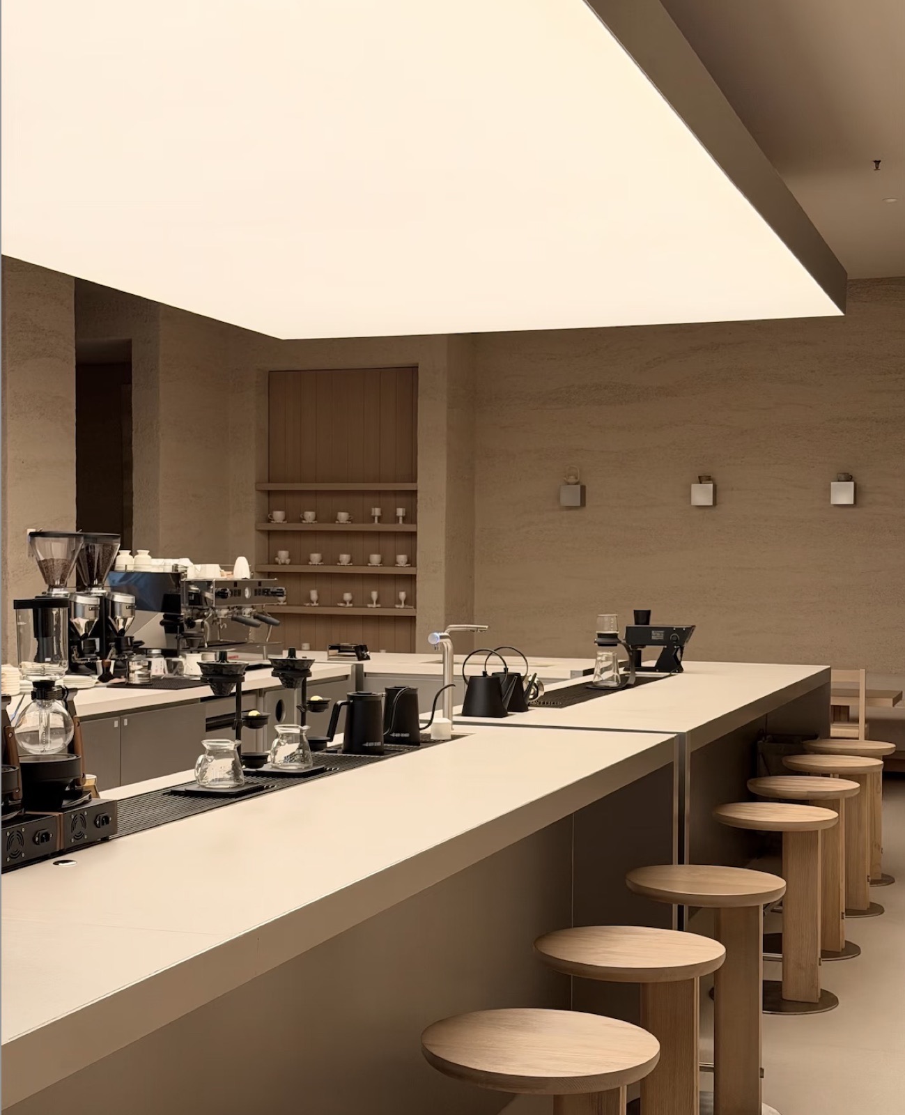 coffee shop, comptoir en L et tabourets bois — projet hôtellerie ayyur interiors.